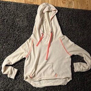 Never worn We the Free sweatshirt. Cream with pink detail on seams.